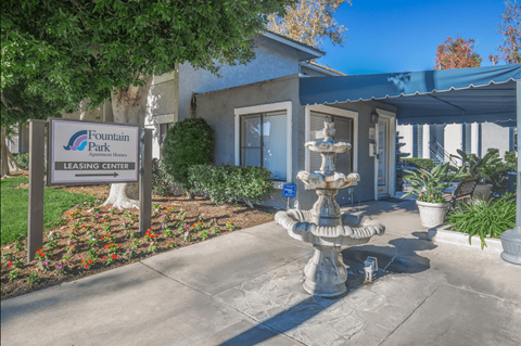 a fountain in front of the fountain park leasing center